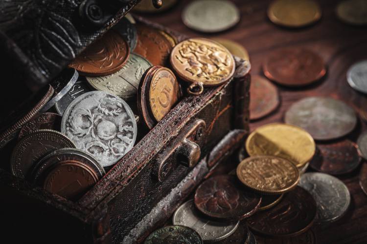 coins falling out of a chest