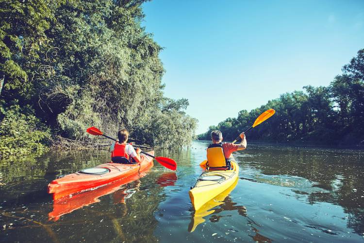 two people in kayaks on the water