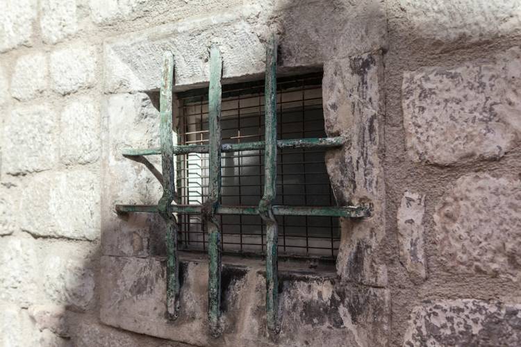 Bar covered window on an old jail